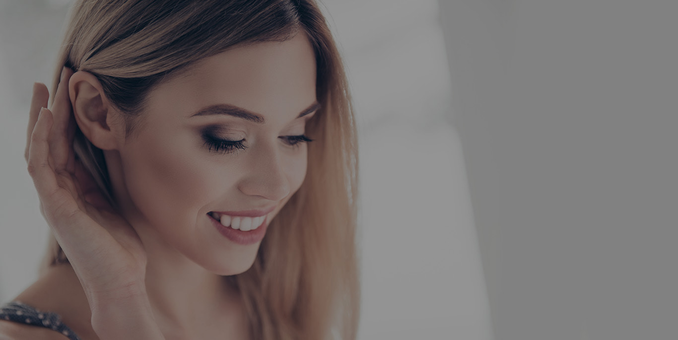woman tucking her hair behind her ear